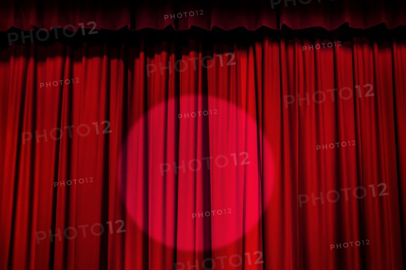 Spotlight on red curtain.