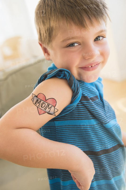 Portrait of boy (6-7) with tatoo on shoulder