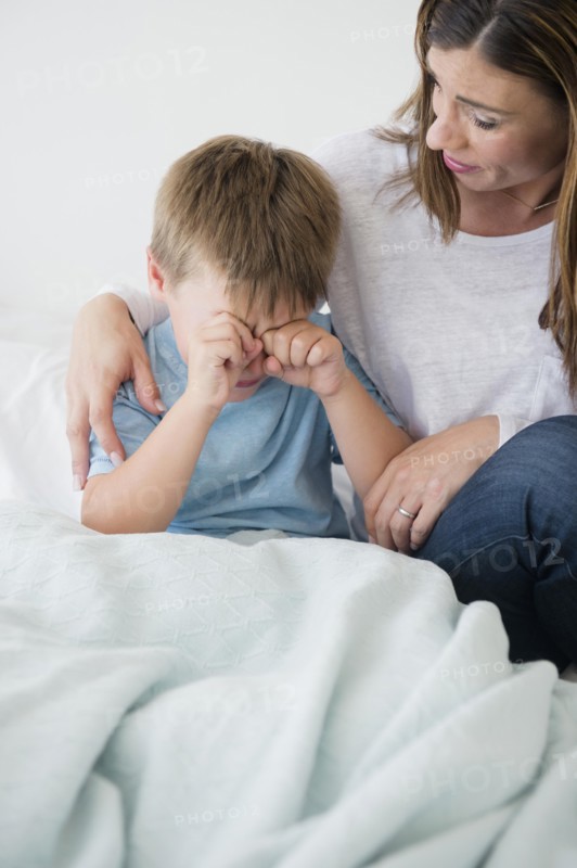 Mother consolling son (6-7)