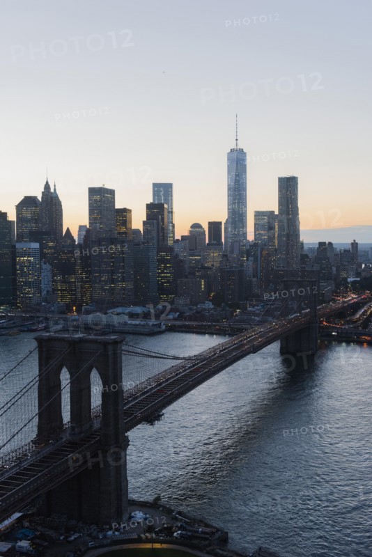 Lower Manhattan, View of Brooklyn Bridge and One World Trade Center at dusk