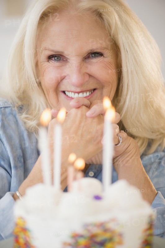 Portrait of senior woman with birthday cake
