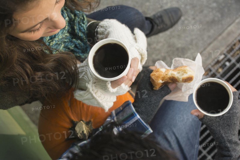 Directly above view of couple drinking coffee