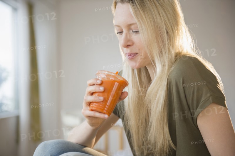 Woman drinking carrot juice