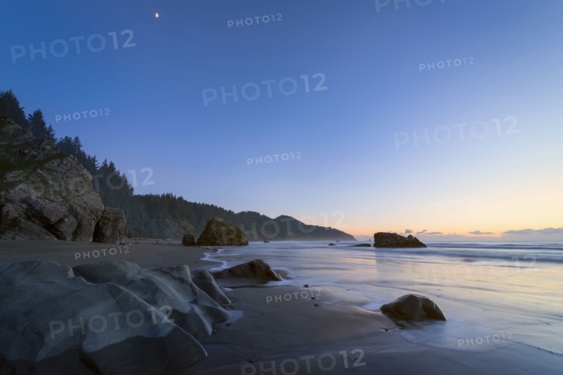 Scenic view of coastline at sunset