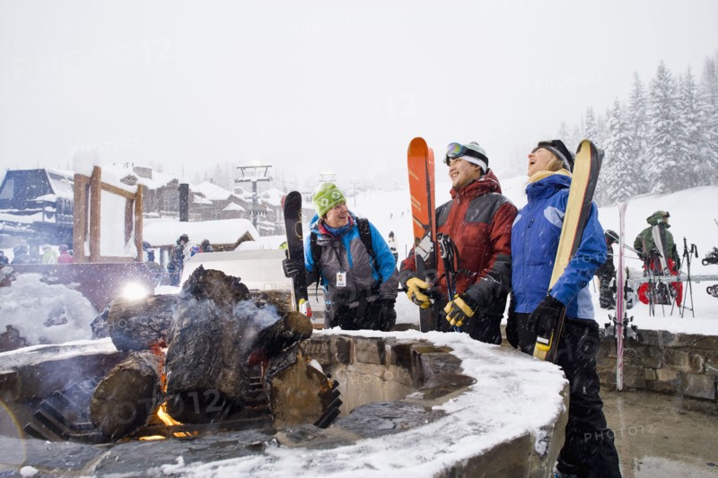 Group of friends with bonfire in winter