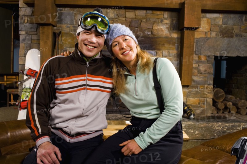Portrait of couple in front of fireplace