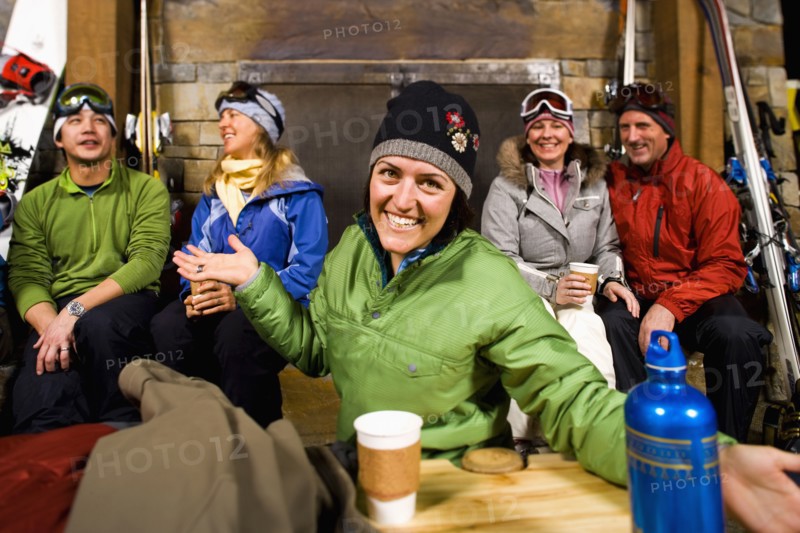 Group of skiers hanging out at fireplace