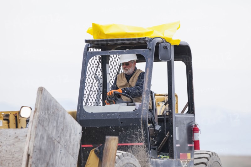Senior man working on earthmover