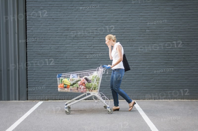 Woman walking with shopping cart