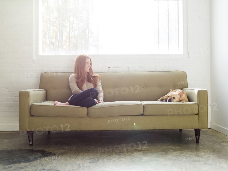 Woman and pug on sofa