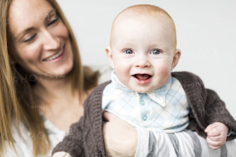 Mother holding baby son (6-11 months)