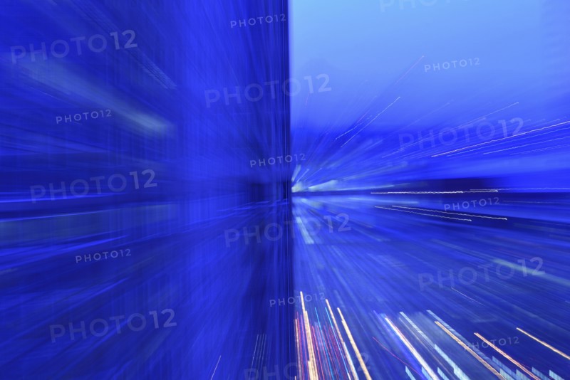 Motion blurred lights at dusk, abstract blue image