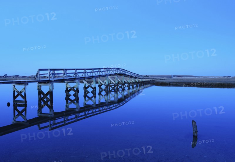 Bridge reflecting in water, blue image