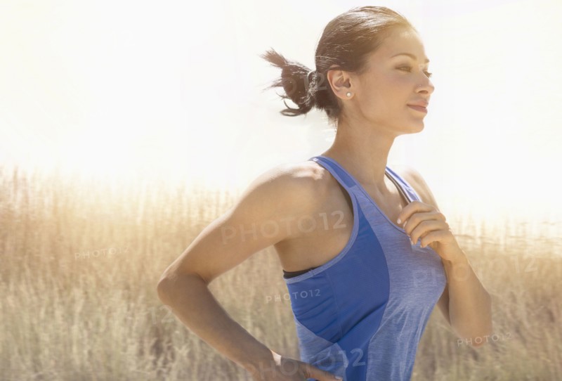Young woman running outdoors.