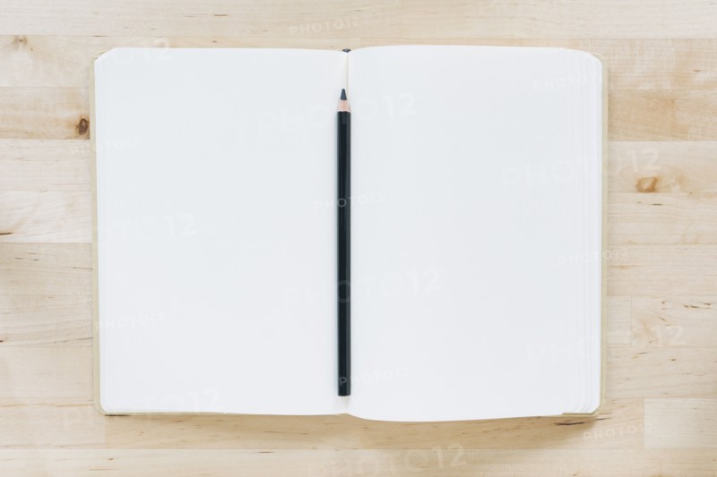 Overhead view of pencil in notebook