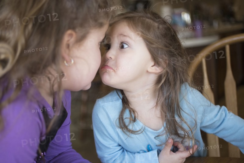 Sisters making faces at each other