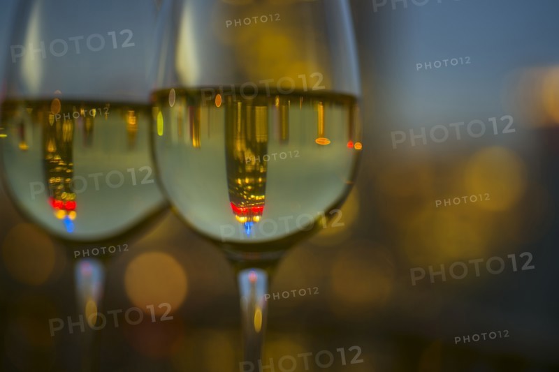 Two wineglasses with white wine. USA, New York, New York City.