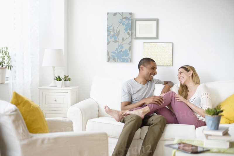 Mid adult couple relaxing in living room.