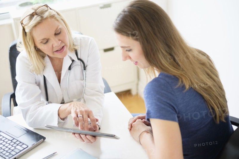 Doctor talking to patient in office.