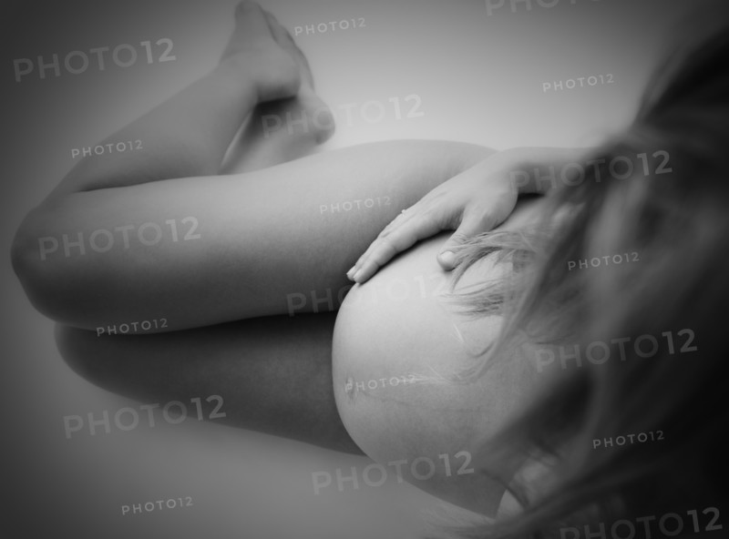 Studio shot of naked, pregnant woman