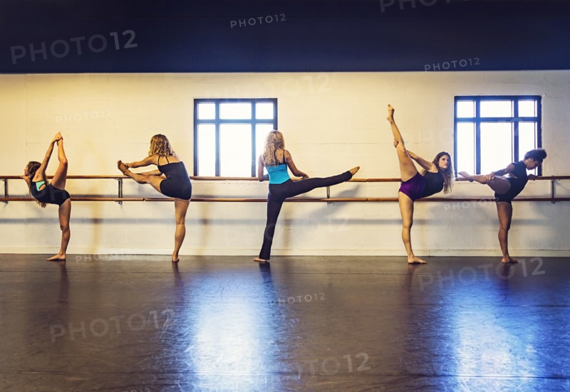 Dancers stretching in dance studio