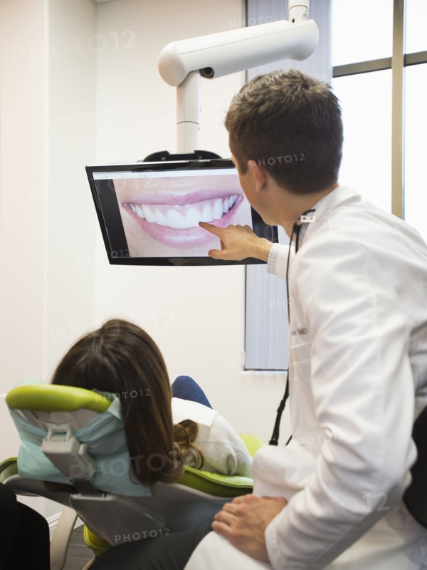 Dentist and patient looking at screen