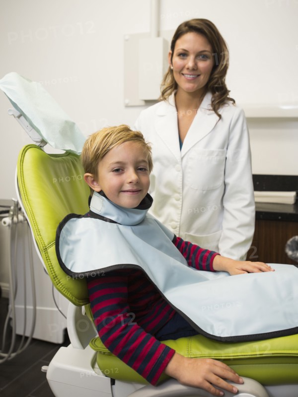 Dentist and patient (8-9) in dentist's office