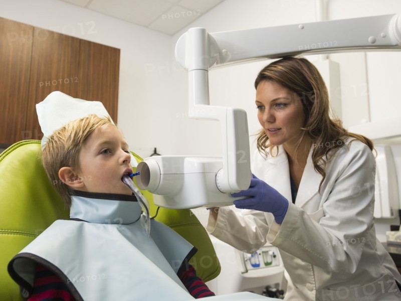 Dentist and patient (8-9) in dentist's office