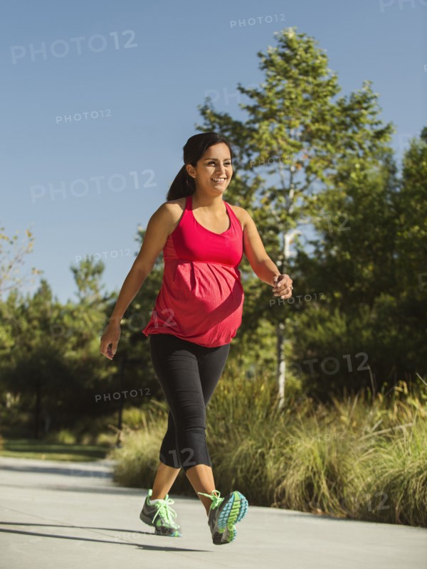 Pregnant woman walking outdoors