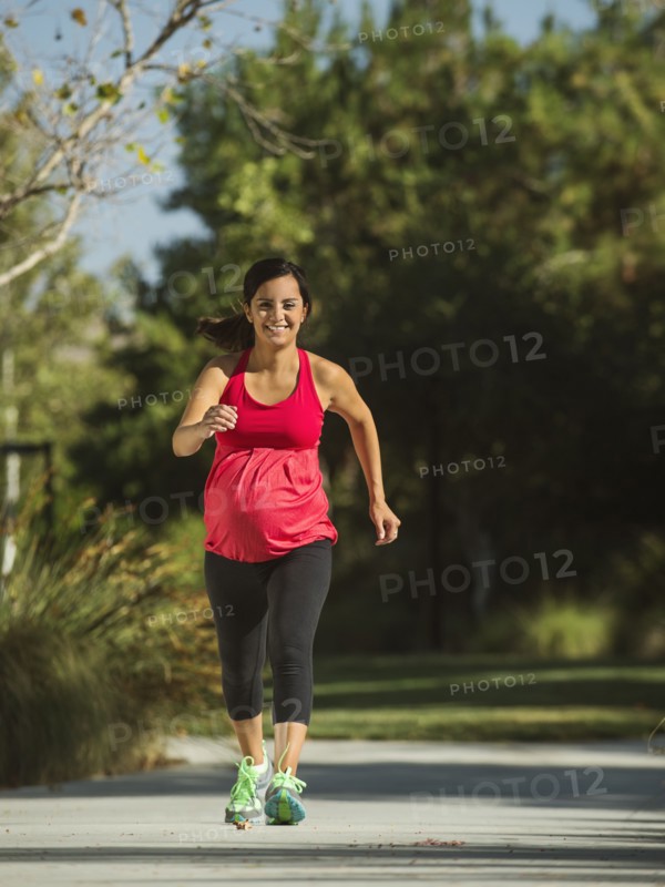 Pregnant woman running outdoors