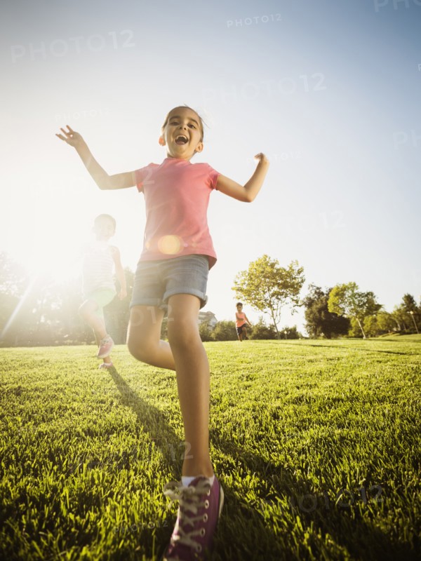 Siblings (2-3, 6-7, 8-9) playing in park