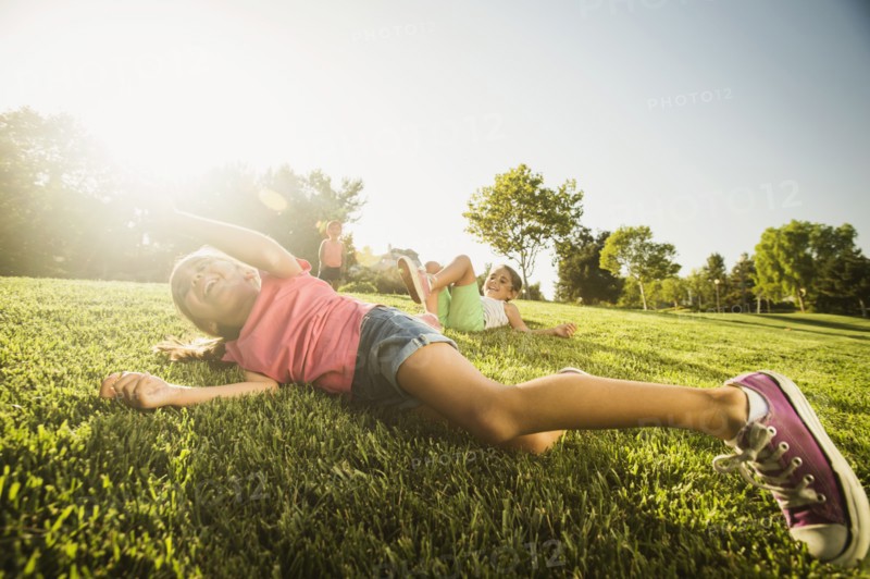 Siblings (2-3, 6-7, 8-9) playing in park