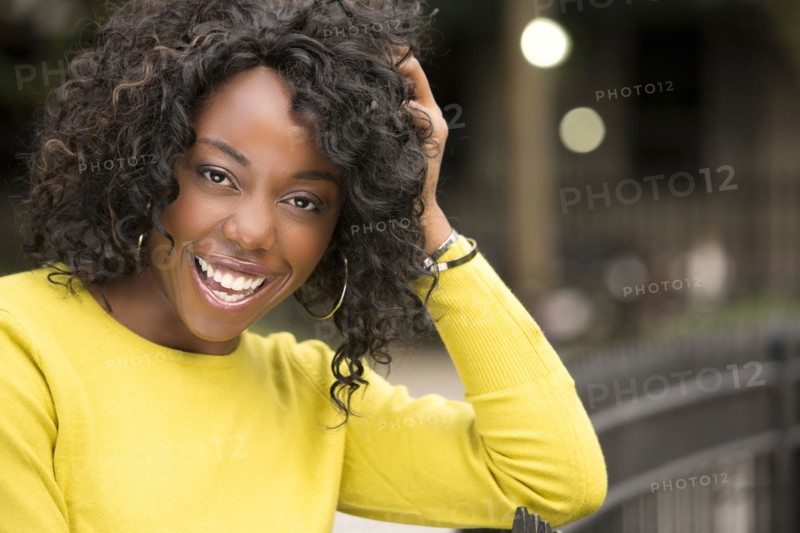 Smiling woman with hand in hair