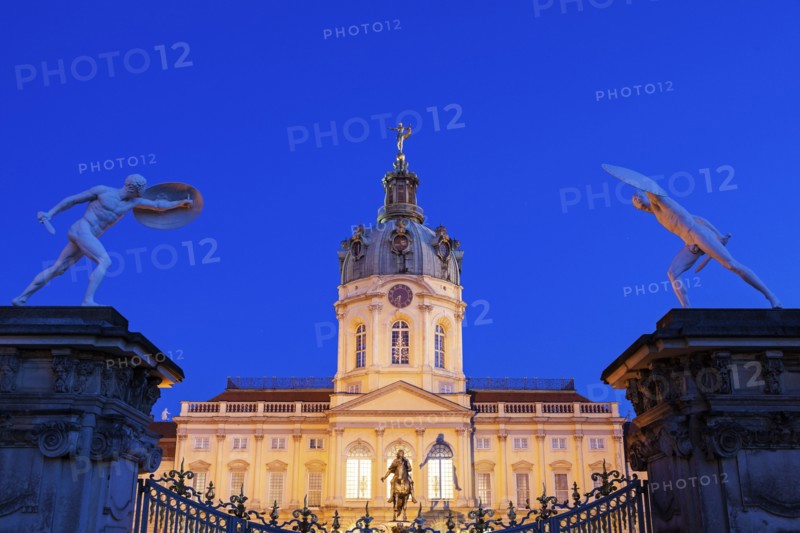 Charlottenburg Palace facade and entrance statues at night