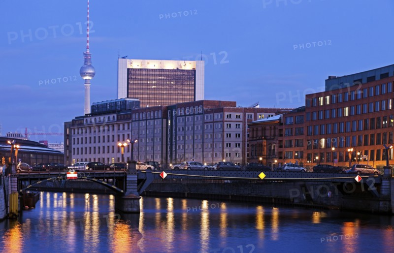 Illuminated riverfront skyline with television tower