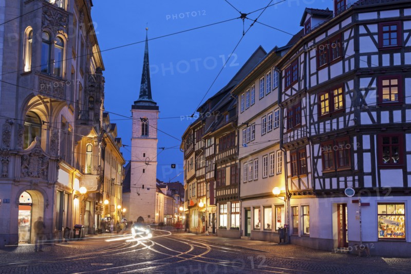 Illuminated city street and Allerheiligenkirche bell tower