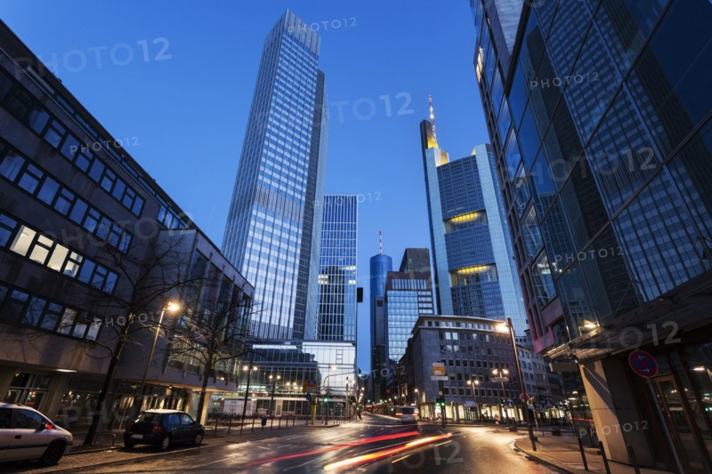 Illuminated city street with skyscrapers