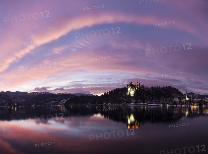 Clouds over Lake Bled and illuminated Church of the Assumption