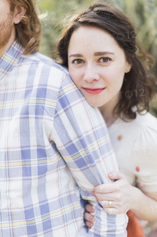 Young smiling woman next to boyfriend