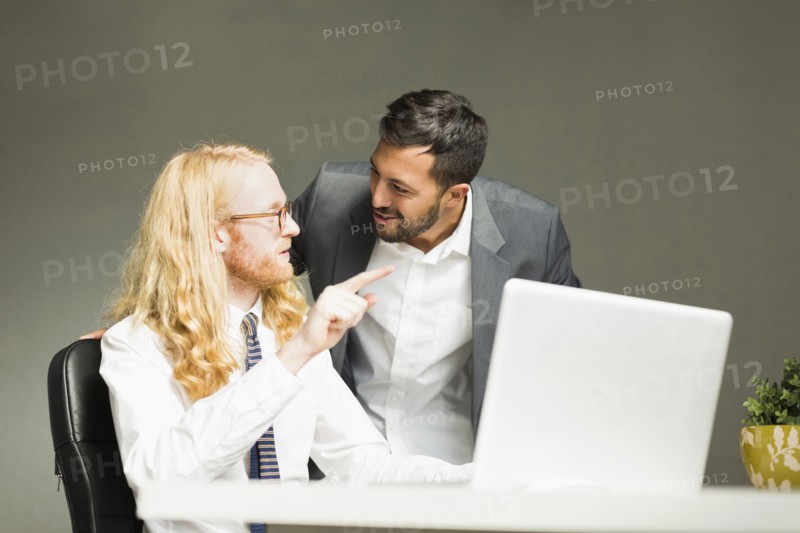 Businessmen talking in office