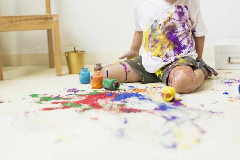 Boy (2-3) painting on carpet