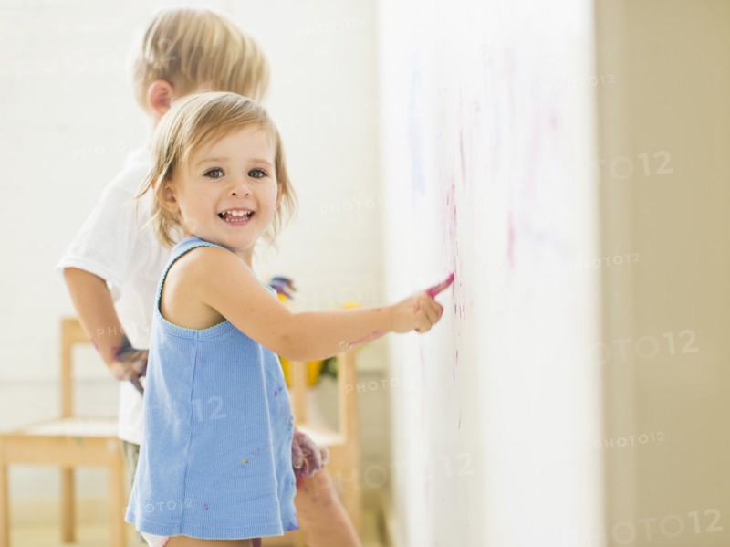 Children (2-3) painting on wall