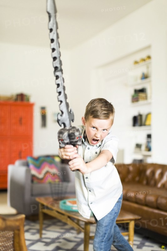 Boy (6-7) playing with sword