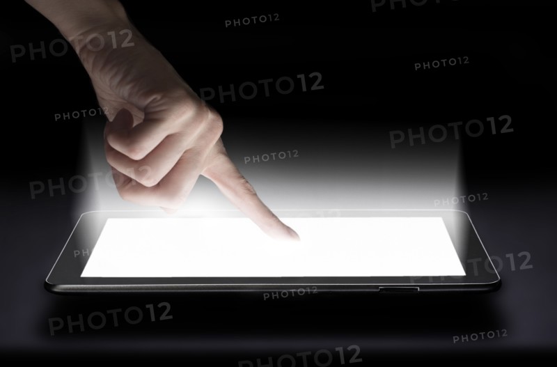 Woman touching digital tablet in studio.