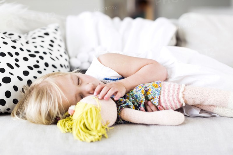 Girl (2-3) napping on sofa