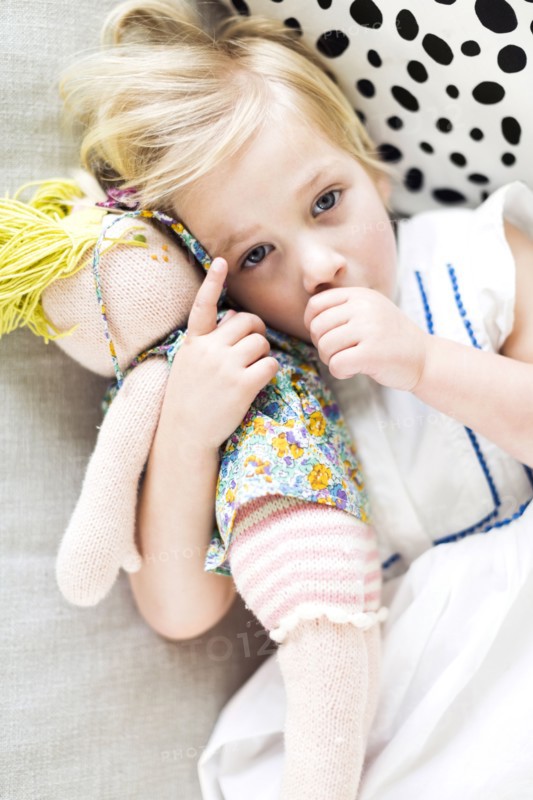 Portrait of girl (2-3) relaxing on sofa