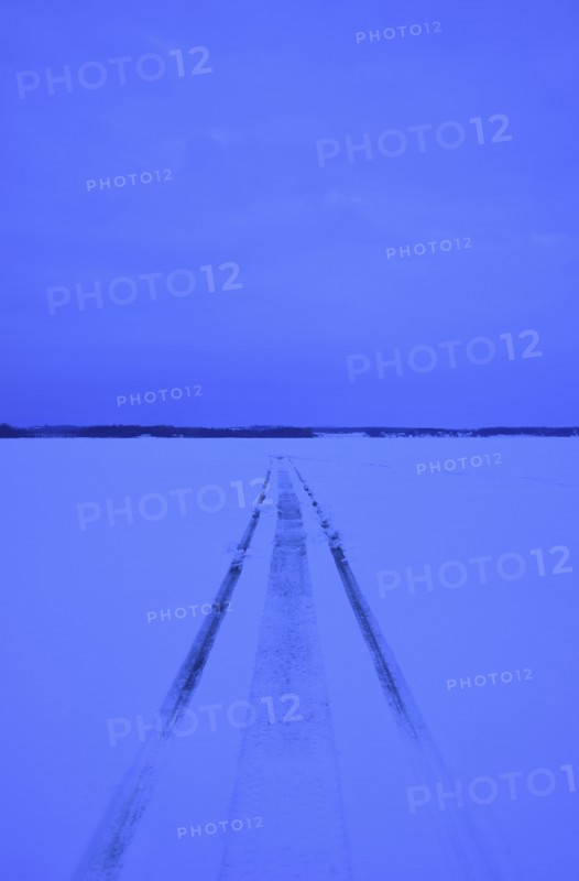 Snowmobile tracks on frozen lake