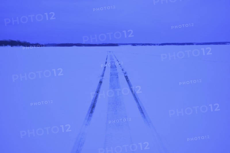 Snowmobile tracks on frozen lake