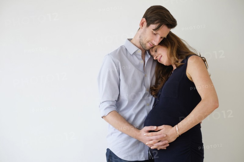 Portrait of content couple holding hands.