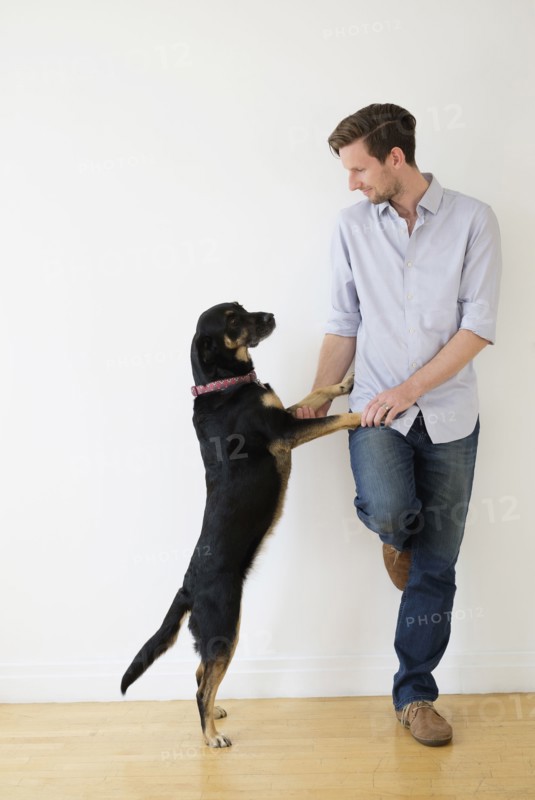 Man playing with dog.